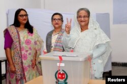 Prime Minister Sheikh Hasina gestures after casting her vote during the general election in Dhaka, Bangladesh, Dec. 30, 2018.