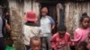 FILE - Residents of Anjezika, one of Antananarivo's poorest and most unhealthy neighborhoods, stand around on May 13, 2020. 