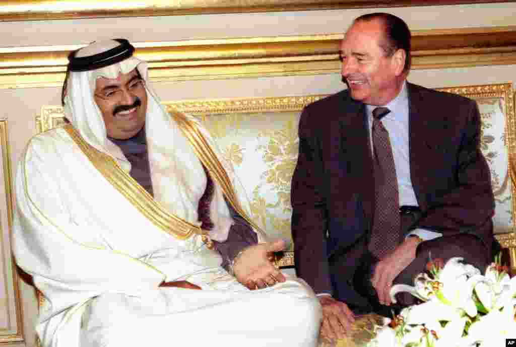 French President Jacques Chirac, right, smiles to Qatar emir Sheikh Hamad bin Khalifa al-Thani prior to their talks at the Elysee Palace December 11, 1996 in Paris.