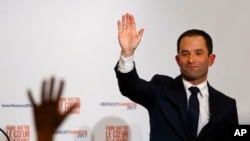 FILE - Benoit Hamon greets supporters after winning the socialist party presidential nomination in Paris, France.