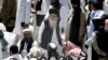 FILE - Pakistan's hard-line cleric Sufi Muhammad, center, arrives to address his supporters in Mingora capital, Swat Valley, April 19, 2009. 