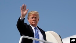 FILE - President Donald Trump waves as he boards Air Force One for a trip to West Virginia for a "Salute to Service" dinner, July 3, 2018, at Andrews Air Force Base, Maryland.