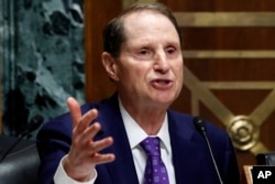 Ranking member of the Senate Finance Committee Sen. Ron Wyden, D-Ore., asks a question of Secretary of Commerce Wilbur Ross during a committee hearing on tariffs, June 20, 2018.