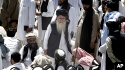 FILE - Pakistan's hard-line cleric Sufi Muhammad, center, arrives to address his supporters in Mingora capital, Swat Valley, April 19, 2009. 