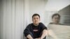 FILE - U.S. citizen Daniel Hsu poses for a portrait in the apartment he has been renting in Shanghai, China, April 13, 2020.