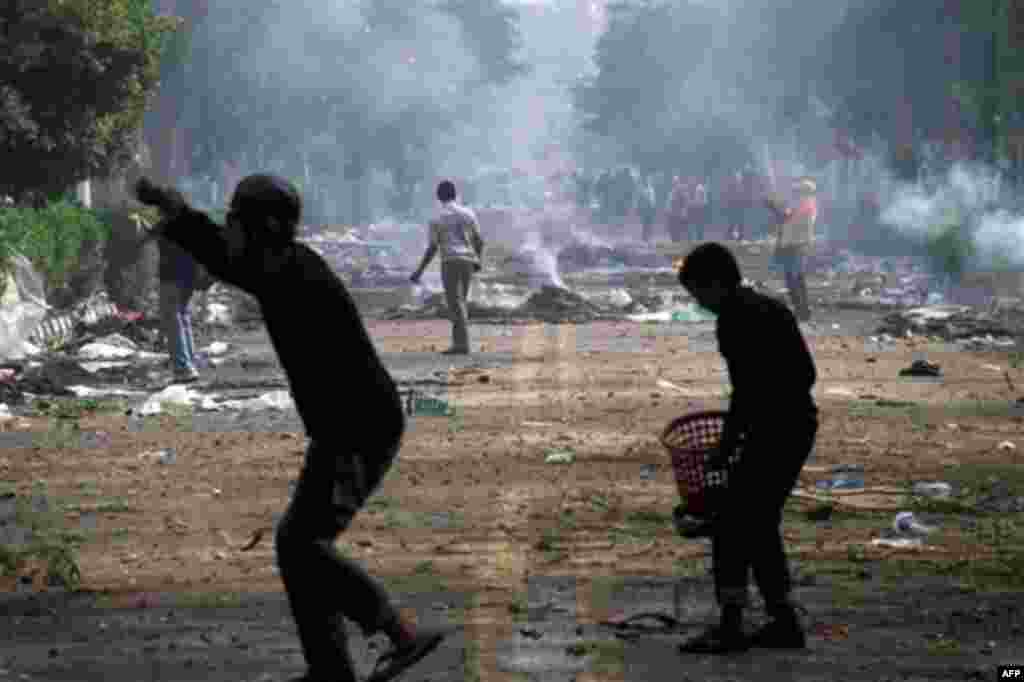 Egyptian protesters throw rocks at military police during clashes near Cairo's downtown Tahrir Square, Egypt, Friday, Dec. 16, 2011. Activists say the clashes began after soldiers severely beat a young man who was part of a sit-in outside the Cabinet buil