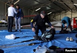 Ibrahim Kalesic, 88-year-old parachuter, prepares his parachute during Para Challenge Cup in Bihac, Bosnia and Herzegovina on September 24, 2022. (REUTERS/Dado Ruvic)