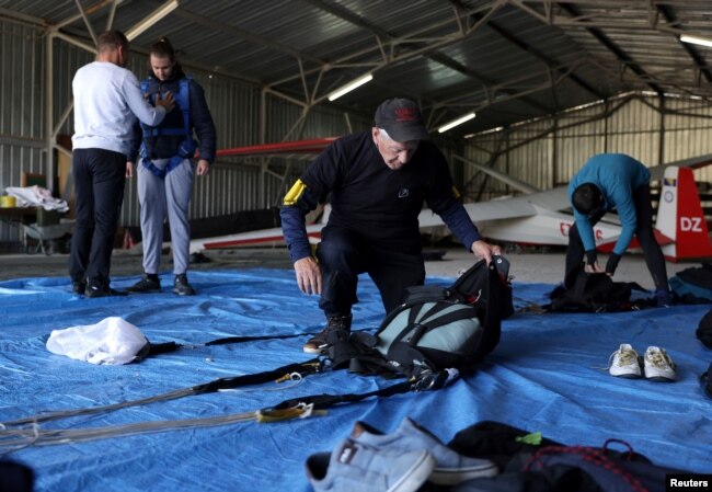 Ibrahim Kalesic, 88-year-old parachuter, prepares his parachute during Para Challenge Cup in Bihac, Bosnia and Herzegovina on September 24, 2022. (REUTERS/Dado Ruvic)