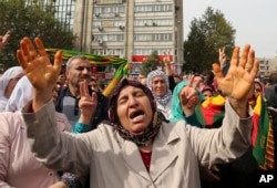 Protesters chant slogans as they protest Saturday's bombing attacks, during a rally in Ankara, Turkey, Sunday, Oct. 11, 2015.