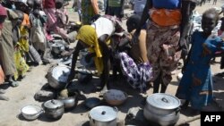 FILE - Women prepare food in a camp for Nigerian refugees in Minawao, Cameroon, Nov. 13, 2014. 