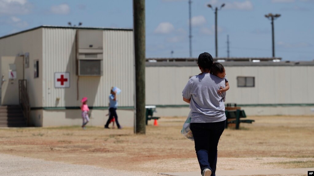 In this Aug. 23, 2019 file photo, immigrants seeking asylum walk at the ICE South Texas Family Residential Center, in Dilley, Texas. (AP Photo/Eric Gay, File) 