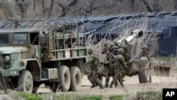 South Korean soldiers prepare 155 mm howitzers during their military exercise in the border city between two Koreas, Paju, north of Seoul, South Korea, April 18, 2013.
