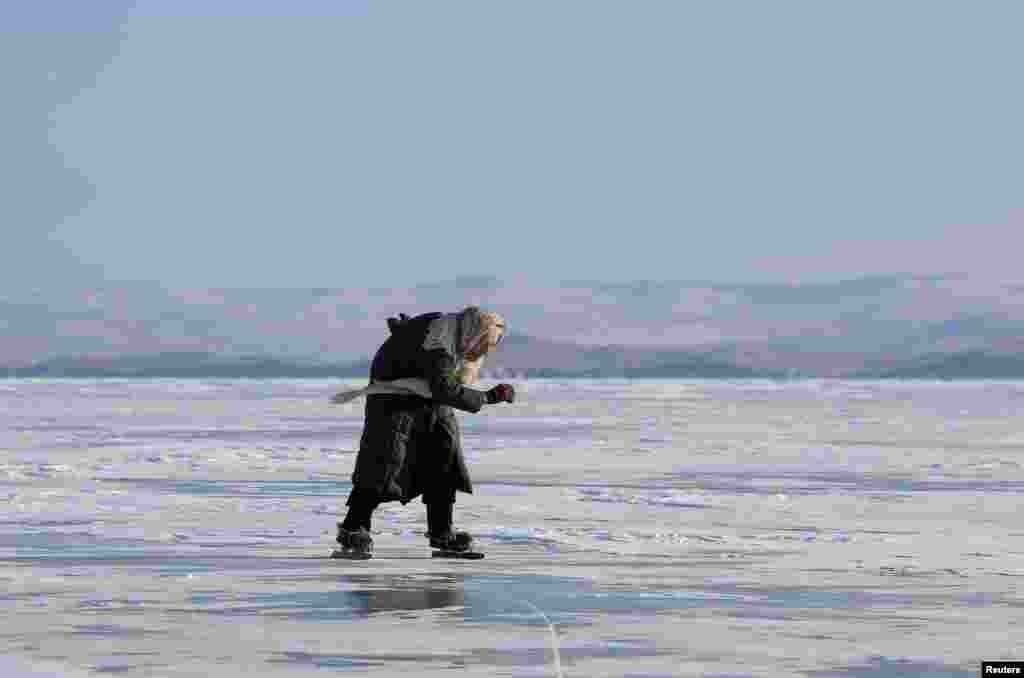 Lyubov Morekhodova, 79, skates on ice-covered Lake Baikal in Irkutsk Region, Russia.