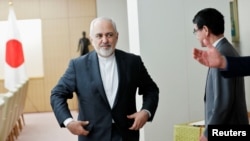 Iranian Foreign Minister Mohammad Javad Zarif is guided to his seat as he meets Japanese Foreign Minister Taro Kono in Tokyo, Japan, May 16, 2019. 