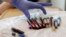 In this photo taken March 21, 2017, a nurse reaches for blood samples taken from a patient receiving a kind of immunotherapy known as CAR-T cell therapy at the Fred Hutchinson Cancer Research Center in Seattle.