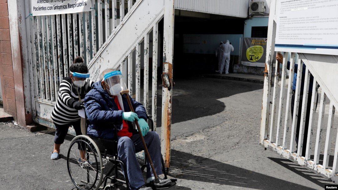 A woman takes her relative showing symptoms of the coronavirus disease (COVID-19) to the emergency area of the San Juan de Dios hospital, in Guatemala City, Guatemala, July 15, 2020. REUTERS/Luis Echeverria