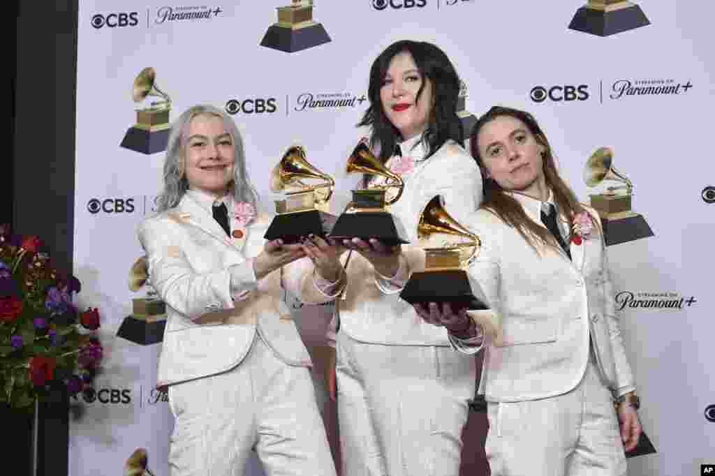 (from left) Phoebe Bridgers, Lucy Dacus, and Julien Baker of Boygenius pose in the press room with the awards for best rock performance and best rock song for &quot;Not Strong Enough,&quot; and best alternative music album for &quot;The Record&quot; during the 66th annual Grammy Awards, Feb. 4, 2024, in Los Angeles, California.&nbsp;