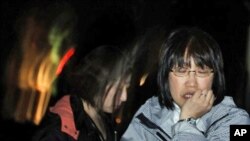 A Japanese woman reacts in Ishinomaki, Iwate Prefecture, northern Japan, after a 7.1 magnitude earthquake struck offshore, late Thursday, April 7, 2011.