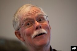 FILE - Retired NASA astrophysicist, author, photographer and eclipse expert Fred Espenak known as "Mr. Eclipse" speaks during a press conference in Torshavn, the capital city of the Faeroe Islands, March 19, 2015.