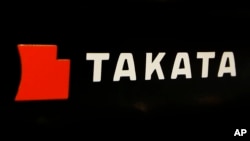 FILE - The logo of Takata Corp. is displayed at an auto supply shop in Tokyo.