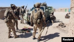 FILE - Afghan Special Forces prepare themselves for battle with the Taliban on the outskirts of Lashkar Gah capital of Helmand, Afghanistan, Oct. 10, 2016. 