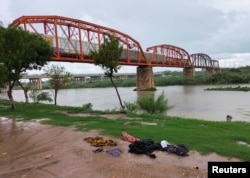 Clothes are seen on the ground of the shore of the Rio Grande river between the U.S. and Mexico after some migrants died and others were rescued as they tried to cross the rain-swollen Rio Grande river into the United States near Eagle Pass, Texas, U.S., in Piedras Negras, Mexico, September 3, 2022. (REUTERS/Carlos Garcia)