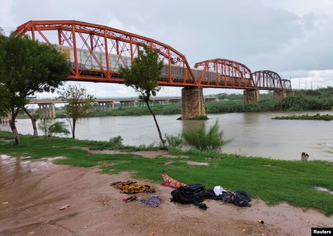 Clothes are seen on the ground of the shore of the Rio Grande river between the U.S. and Mexico after some migrants died and others were rescued as they tried to cross the rain-swollen Rio Grande river into the United States near Eagle Pass, Texas, U.S., in Piedras Negras, Mexico, September 3, 2022. (REUTERS/Carlos Garcia)