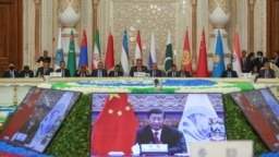 FILE - Participants listen to China's President Xi Jinping's speech via a video link during the Shanghai Cooperation Organization summit in Dushanbe, Tajikistan, Sept. 17, 2021. Saudi Arabia has agreed to partner with the group, Saudi state media said March 29, 2023.
