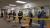 Health care workers wait in line to receive the Pfizer-BioNTech COVID-19 vaccine at Seton Medical Center in Daly City, Calif., Dec. 24, 2020. 