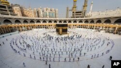 FILE - In this July 31, 2020, photo, pilgrims walk around the Kabba at the Grand Mosque in the Muslim holy city of Mecca, Saudi Arabia. 