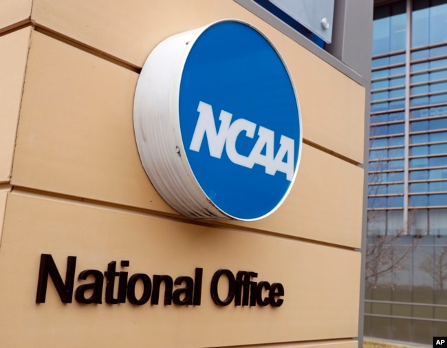 FILE - Signage is on the headquarters of the NCAA in Indianapolis, March 12, 2020. (AP Photo/Michael Conroy, File)