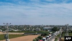 FILE - This aerial view shows humanitarian aid trucks arriving from Egypt after having crossed through the Rafah border crossing arriving at a storage facility in Khan Yunis in the southern Gaza Strip on October 21, 2023.