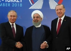 Iran's President Hassan Rouhani, center, flanked by Russia's President Vladimir Putin, left, and Turkey's President Recep Tayyip Erdogan, pose for photographs in Tehran, Iran, ahead of their summit to discuss Syria, Sept. 7, 2018.