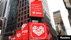 FILE - A display at the Thomson Reuters building shows a message after Chinese online group discounter Pinduoduo Inc. (PDD) was listed on the Nasdaq exchange in Times Square in New York City, New York, July 26, 2018.