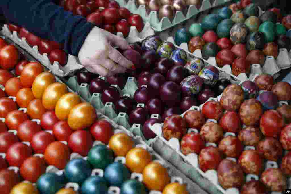 A buyer chooses hand decorated Easter eggs at a market in Belgrade, Serbia. Orthodox Serbs celebrate Easter on April 16, according to old Julian calendar.
