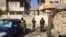 Soldiers search cars and houses for bombs and weapons as they transport detainees in Mosul, Iraq, Jan. 23, 2017. (H. Murdock/VOA)