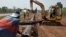FILE - Workers of Ivory Coast Kuyo pipeline company assemble pipelines in Tiebissou, near Abidjan, the economical capital of Ivory Coast.
