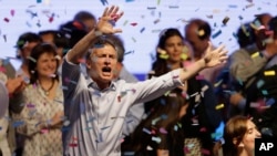 Top opposition presidential candidate Mauricio Macri dances and sings after speaking to supporters in Buenos Aires, Argentina, Sunday, Oct. 25, 2015.