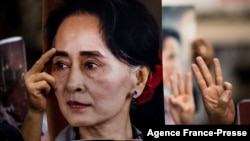 FILE - A protester holds a photo of detained Myanmar civilian leader Aung San Suu Kyi during a demonstration against the military coup outside the Myanmar Embassy in Bangkok on Feb. 7, 2021.