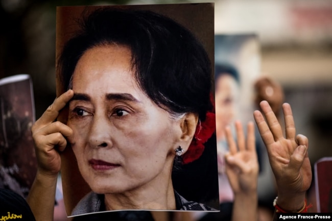 FILE - A protester holds a photo of detained Myanmar civilian leader Aung San Suu Kyi during a demonstration against the military coup outside the Myanmar Embassy in Bangkok on Feb. 7, 2021.