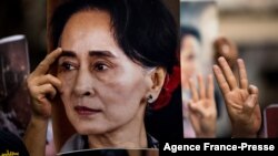 FILE - A protester holds a photo of detained Myanmar civilian leader Aung San Suu Kyi during a demonstration against the military coup outside the Myanmar Embassy in Bangkok on Feb. 7, 2021.