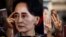 FILE - A protester holds a photo of detained Myanmar civilian leader Aung San Suu Kyi during a demonstration against the military coup outside the Myanmar Embassy in Bangkok on Feb. 7, 2021.