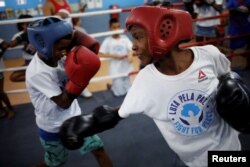 Children practice during an exercise session at a boxing school, in the Mare favela of Rio de Janeiro, Brazil, June 2, 2016.