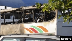 A burnt bus is seen at Bulgaria's Burgas airport July 18, 2012. At least three people were killed and more than 20 injured by an explosion on the bus carrying Israeli tourists Wednesday outside the airport of the Black Sea city.