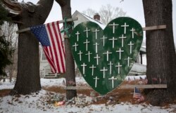 FILE - A heart is emblazoned with crosses to commemorate the Sandy Hook Elementary School shooting victims in Sandy Hook village in Newtown, Connecticut, Dec. 13, 2013.