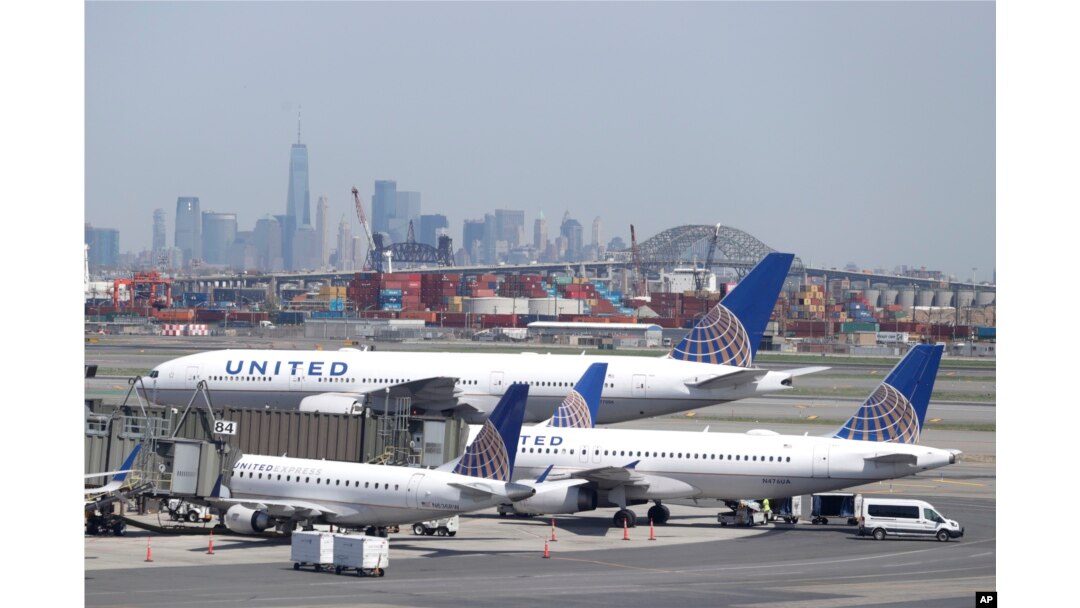 The New York City skyline is seen in the distance as United Airlines jets sit at gates at Newark Liberty International Airport, May 2, 2018, in Newark, New Jersey.