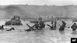 Assault troops hit the beach of Normandy, France, on June 6, 1944