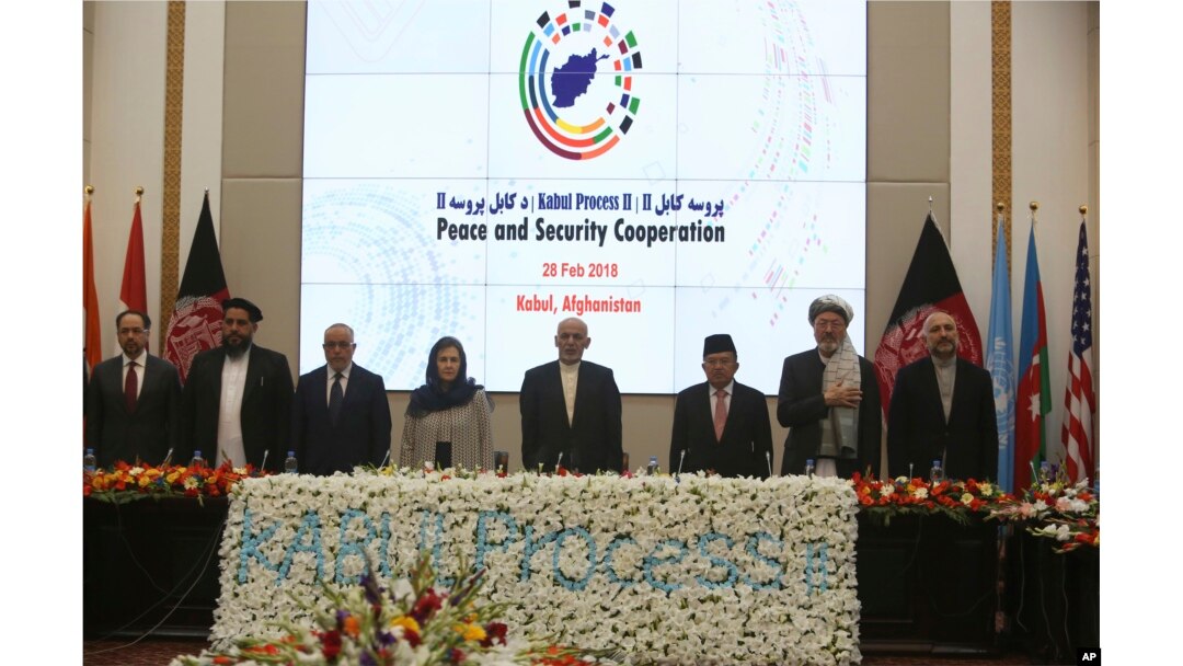 FILE - Afghan President Ashraf Ghani, center, and delegates stand for the national anthem during the second Kabul Process conference at the Presidential Palace in Kabul, Feb. 28, 2018. Ghani used the conference to extend a peace talks off to the Taliban. The group has yet to respond.