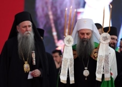 Serbian Orthodox Church's patriarch Porfirije (R) and bishop Joanikije walk through the crowd in front of the Orthodox cathedral in Podgorica, Sept. 4, 2021, to celebrate and show support for enthronement of new bishop of Serbian Orthodox Church.