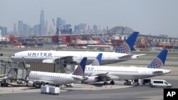 The New York City skyline is seen in the distance as United Airlines jets sit at gates at Newark Liberty International Airport, May 2, 2018, in Newark, New Jersey. 